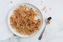 Load image into Gallery viewer, maple pecan granola on plate with spoon.
